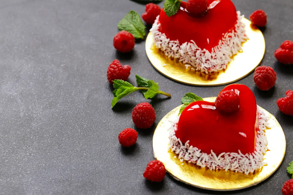 Romantic heart-shaped cake decorated with frosting and edible flowers