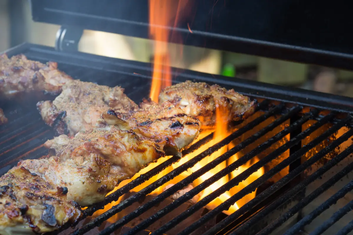 Smoking chicken on a grill with wood chips