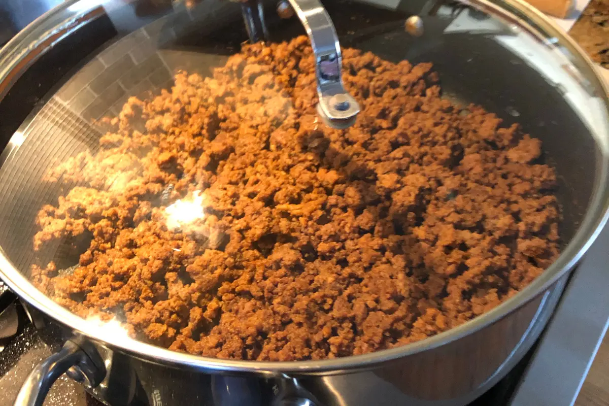 Water being added to cooking taco meat