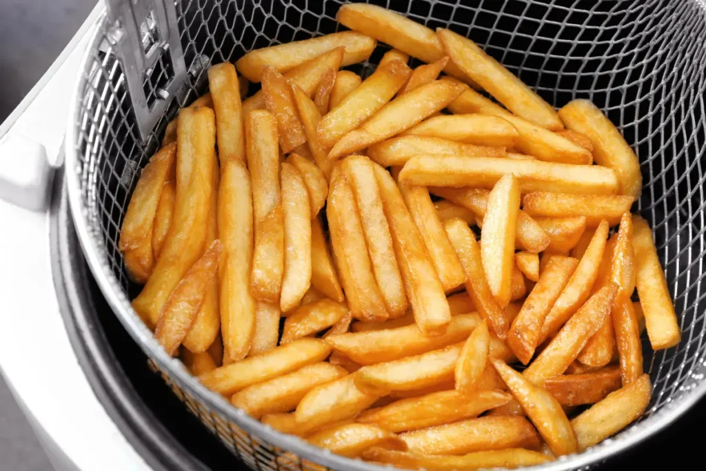 Frozen fries being cooked in an air fryer