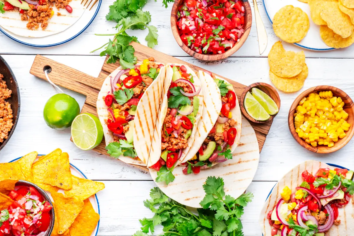 Festive table spread of Mexican tacos and sides