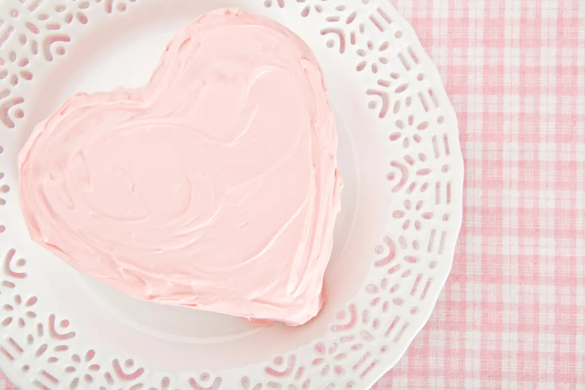 Assembling a heart-shaped cake from square and round cakes