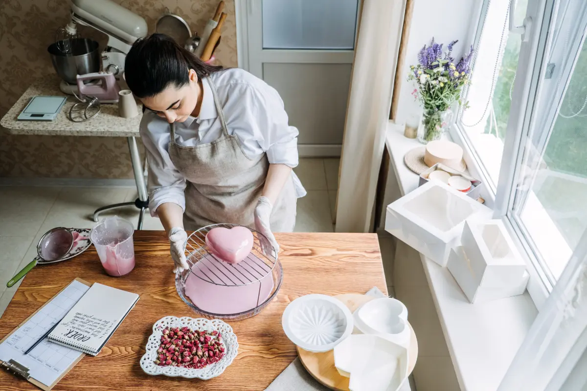 Decorating a heart-shaped cake with colorful frosting