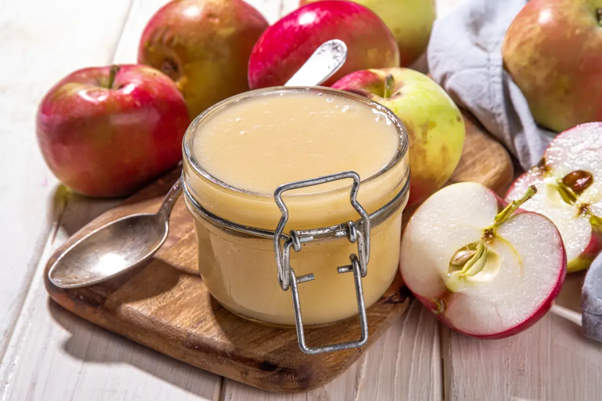 A bowl of enhanced store-bought applesauce with cinnamon sprinkled on top.